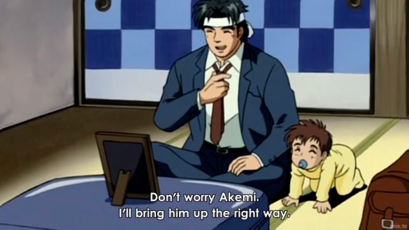 Kintaro and Baby Ryuta looking at a picture frame of Kintaro's dead wife, Akemi. Subtitles read, Don't worry Akemi. I'll bring him up the right way. End subtitle